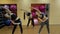 Group of young girls doing stretching exercise in gym.