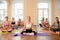 Group of young girls practices yoga in lotus position