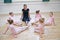 Group Of Young Girls With Teacher In Ballet Dancing Class