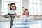 Group of young happy woman practice yoga poses indoor class. Group training