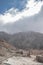 A group of young hikers walking through a landscape of a burned forest around the Volcanic cone in the danger zone in the