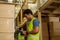 Group of young industrial factory warehouse workers working in logistic industry indoor. Asian and Indian ethnic men man