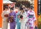 Group of young Japanese girls in traditional kimono costumes on the street