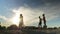 Group of young joyful friends playing volleyball at the sandy beach