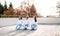 Group of young karate women sitting outdoors on terrace, meditating.