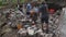 Group of young males working collectively as laborers during daytime in Terragnolo, Italy