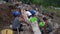 Group of young males working collectively as laborers during daytime in Terragnolo, Italy