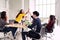 Group of young multiethnic diverse people gesture hand high five, laughing and smiling together in brainstorm meeting at office.