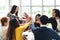 Group of young multiethnic diverse people gesture hand high five, laughing and smiling together in brainstorm meeting at office.