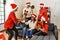 Group of young people celebrating christmas singing carol song at home