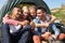 Group Of Young People Checking Mobile Phone On Camping Trip