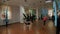 Group of young people doing stretching. Aerial yoga exercise or antigravity yoga