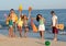 Group of young people enjoying beach party with guitar and balloons