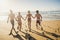 Group of young people friend have fun at the beach in summer holiday vacation running from sand to sea water together in