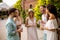 A group of young people gather outdoors to enjoy each other`s company and refreshing glasses of lemonade