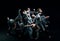 Group of young people in gray stage costumes making performance, dancing against black studio background. Concept of