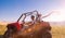 Group of young people having fun while driving a off road buggy car