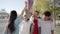 Group of young people having fun together and stacking hands outdoors. Portrait of multiethnic students