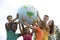 Group of young people holding a globe earth