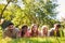 Group of young people laughing lies in a meadow