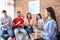 Group of young people learning sign language with teacher