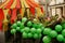 A group of young people masked in green costume surrounded by green balloons cheerful walk in the carnival procession