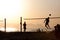 Group of young people playing footvolley on the beach