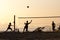 Group of young people playing footvolley on the beach