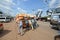 A group of young people pushing a cart overloaded bags