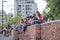 Group of young people sitting outdoors at a reading activity, using face masks