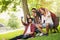 Group of young people taking a selfie outdoors on the bench, having fun