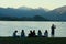 Group of young people watching sunset at lake Wanaka