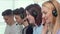 Group of young people wearing headsets, working at call center