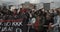 Group of young protestors with mixed nationalities black and caucasian holding up signs against Police Brutality and