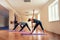 Group of young slim women stretch in yoga class