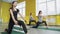 Group of young sporty attractive women practicing yoga lesson with instructor, standing together. Warrior one pose, working out