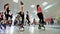 Group of young sporty caucasian women doing fitnes exercises with kangoo jumps.