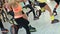 Group of young sporty caucasian women doing fitnes exercises with kangoo jumps shoes in a gym.