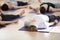 Group of young sporty people in Savasana pose