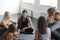 Group of young sporty smiling people talking after yoga class