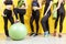 Group of young sporty women standing at wall. Students taking a rest from fitness activity, time to recover strength, waiting for