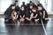 Group of young students of modern ballet dancing course sitting on the floor