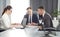 Group of young successful businessmen lawyers communicating together in a conference room while working on a project