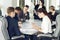 Group of young successful businessmen lawyers communicating together in a conference room while working on a project