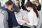 Group of young successful businessmen lawyers communicating together in a conference room while working on a project