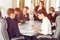 Group of young successful businessmen lawyers communicating together in a conference room while working on a project