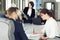 Group of young successful businessmen lawyers communicating together in a conference room while working on a project