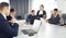 Group of young successful businessmen lawyers communicating together in a conference room while working on a project