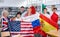 Group of young teenagers people holding international flags of many countries while studying