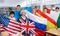 Group of young teenagers people holding international flags of many countries while studying